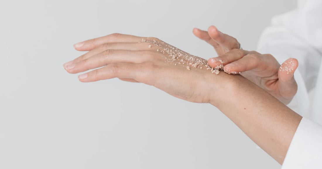 Woman exfoliating her hands
