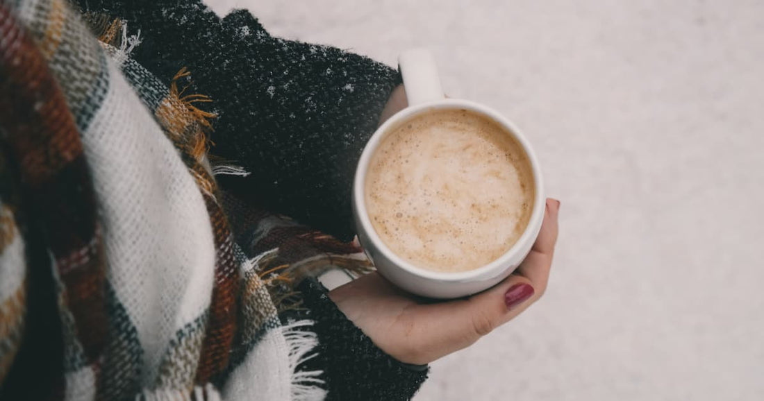 Woman holding a coffee cup in winter